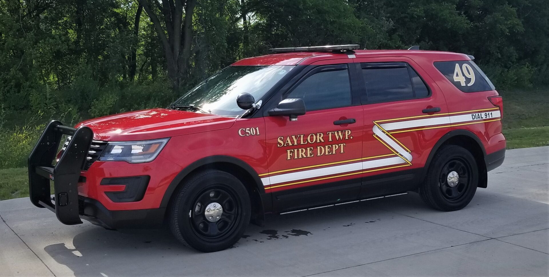 A red police car with the words " savlor twp fire dept." on it.